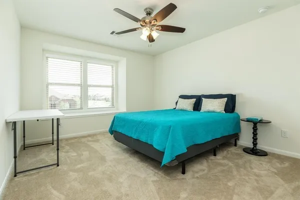 a bedroom with a bed and window
