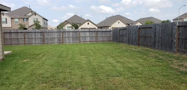 a view of a house with a wooden fence