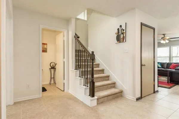 a view of a hallway with closet and a livingroom view