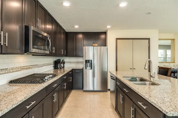 a kitchen with a sink stove and refrigerator