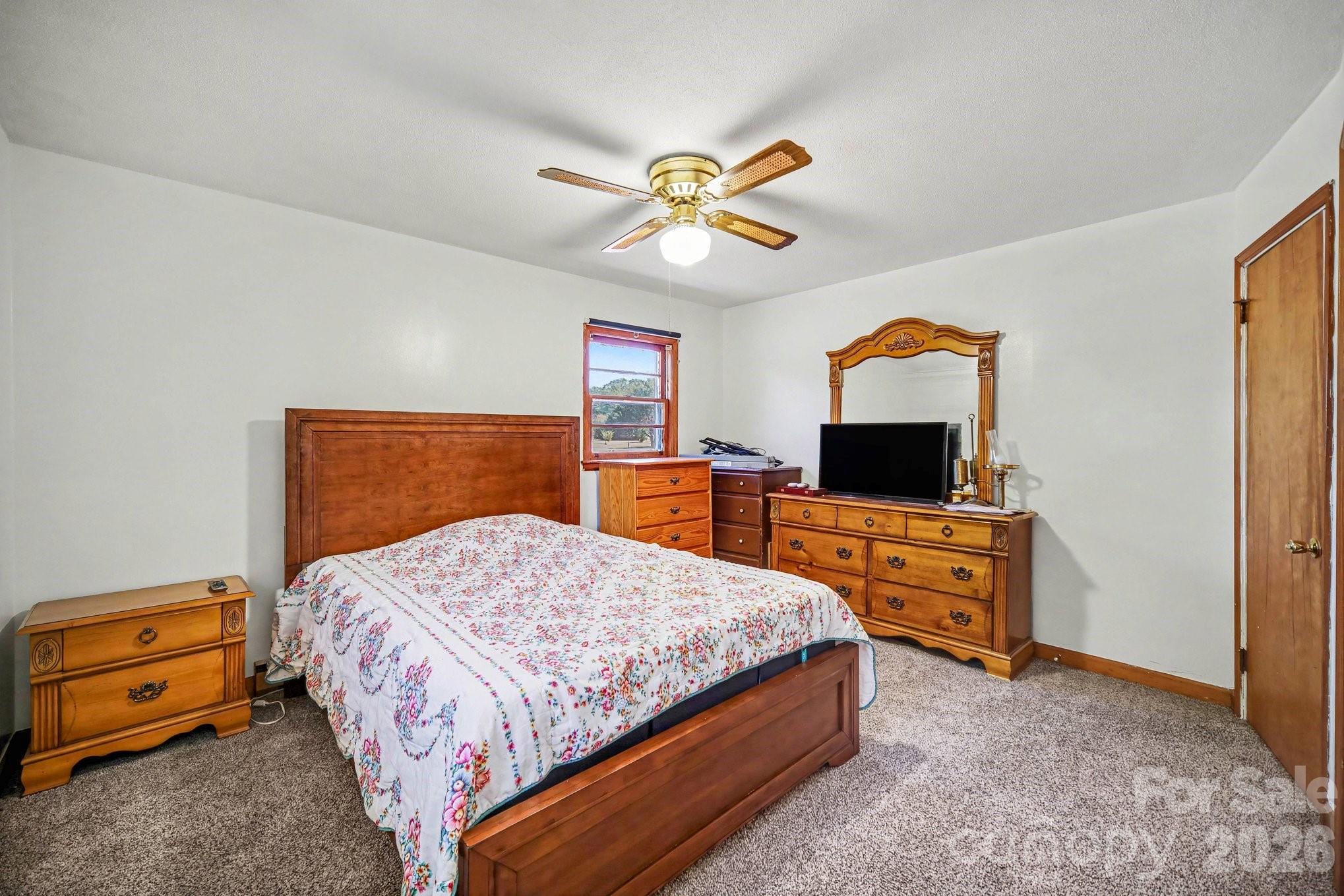 1145 Craigbrow Circle Chester, SC 29706 - Photo 13 of 27 a bedroom with a bed and a flat tv screen on dresser