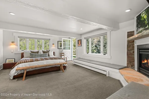 a spacious bedroom with a bed and a large window
