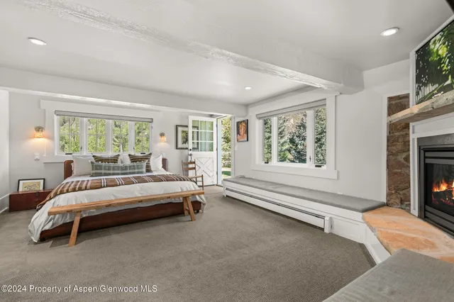 a spacious bedroom with a bed and a large window