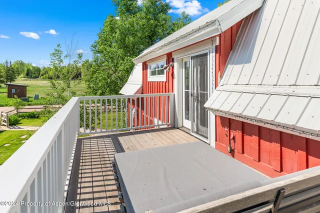 a view of balcony with wooden floor and fence