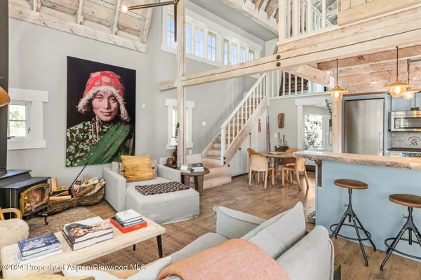 a view of a livingroom with furniture and a window