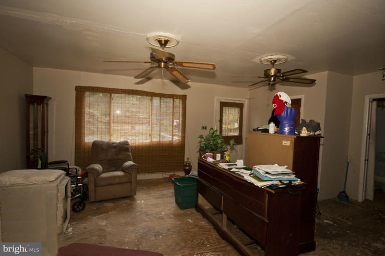 2842 Lodge Farm Road Sparrows Point, MD 21219 - Photo 1 of 8 a living room with furniture and a window