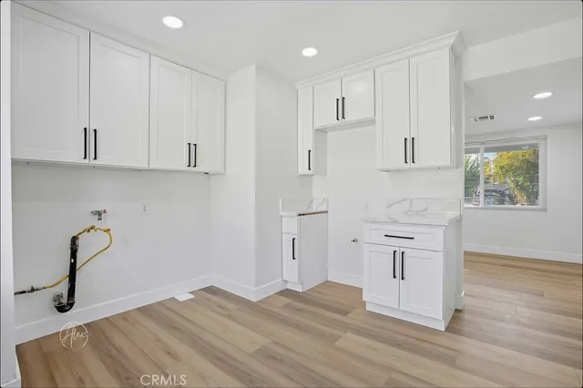 a view of a kitchen with wooden floor