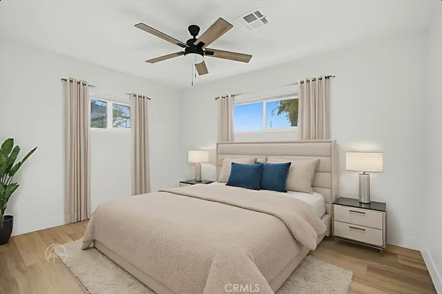 a bedroom with a large bed and a chandelier