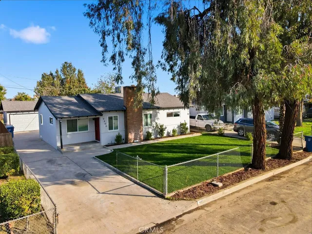 a front view of a house with a yard table and chairs