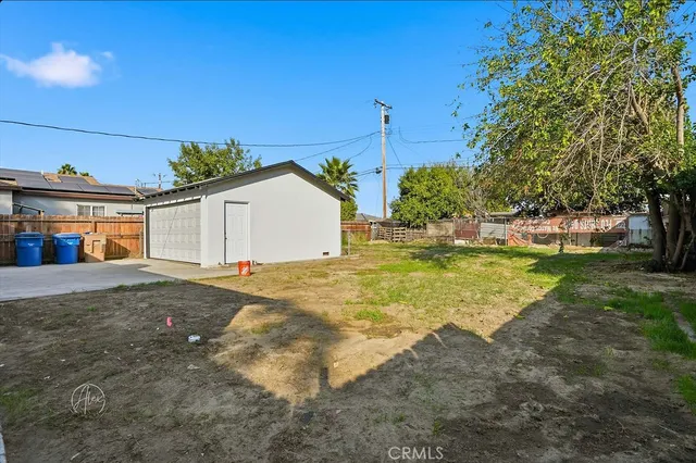 a view of a house with a yard and garage
