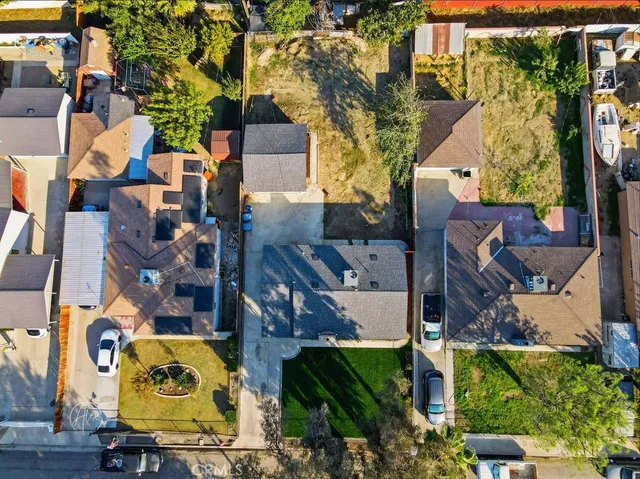 an aerial view of residential houses with outdoor space