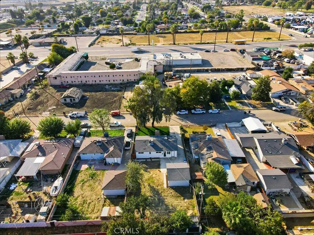 an aerial view of residential houses with outdoor space and lake view
