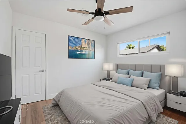 a bedroom with bed and wall painting