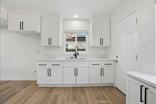 a view of white cabinets and sink