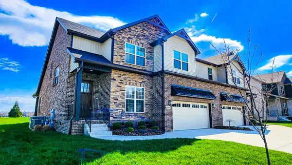 a front view of a house with a yard