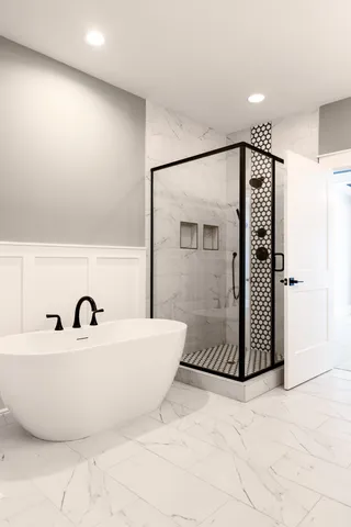 a bathroom with a bathtub and shower