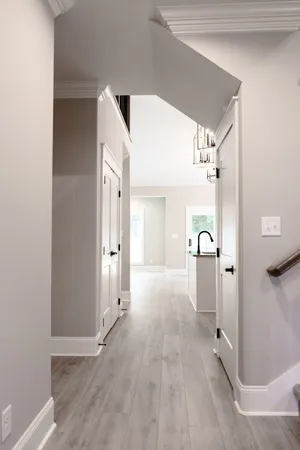 a view of a hallway with wooden shelves