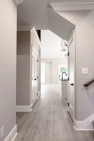 a view of a hallway with wooden shelves