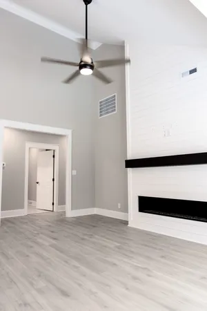 a view of an empty room with wooden floor