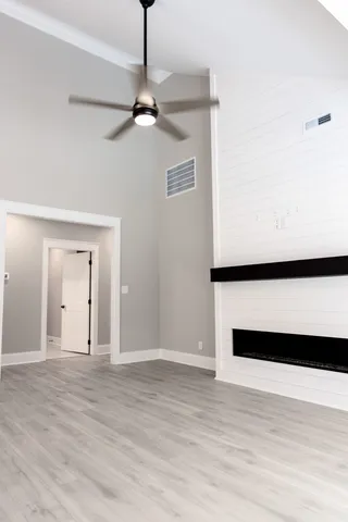 a view of an empty room with wooden floor