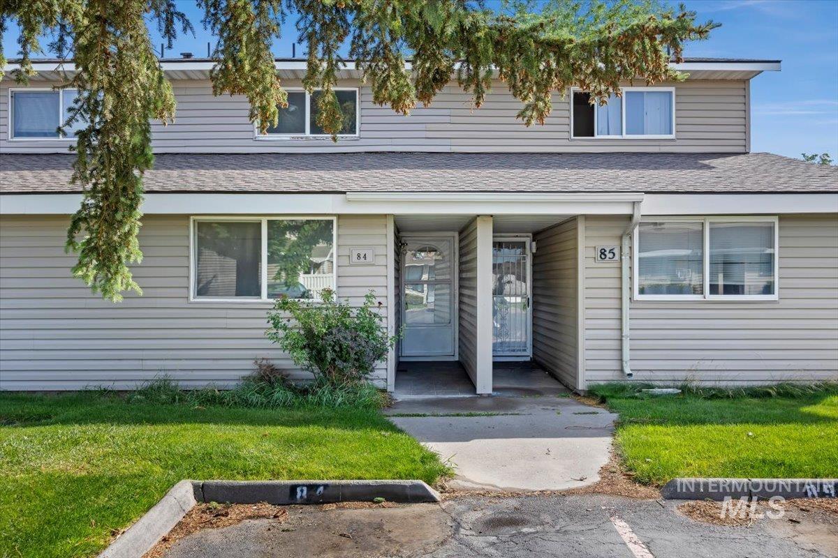259 Pheasant Road, Unit 84 Twin Falls, ID 83301 - Photo 1 of 25 Two-story duplex featuring light-colored siding, multiple windows with white trim, and a shingle roof