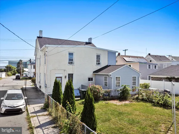 a front view of house with yard outdoor seating and barbeque oven