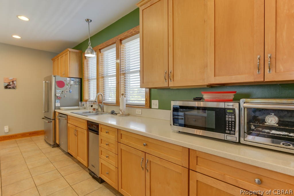 32 Riley's Way Hampton, VA 23664 - Photo 21 of 50 Kitchen with appliances with stainless steel finishes, sink, light tile floors, and pendant lighting