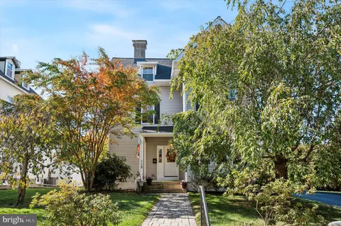a view of a house with a tree and plants