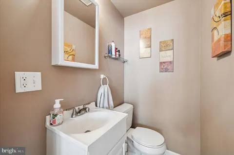 a bathroom with a sink mirror and toilet