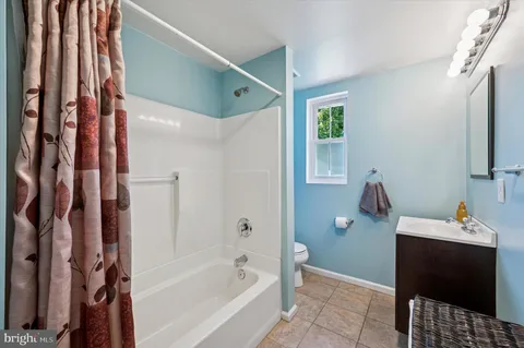 a bathroom with a bathtub and a sink