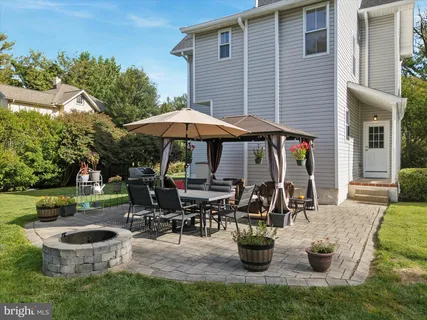 a view of a patio with chairs and table under an umbrella