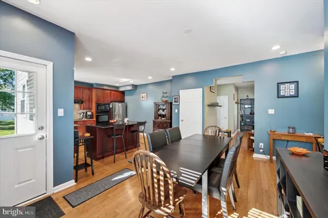 a dining room with furniture and wooden floor