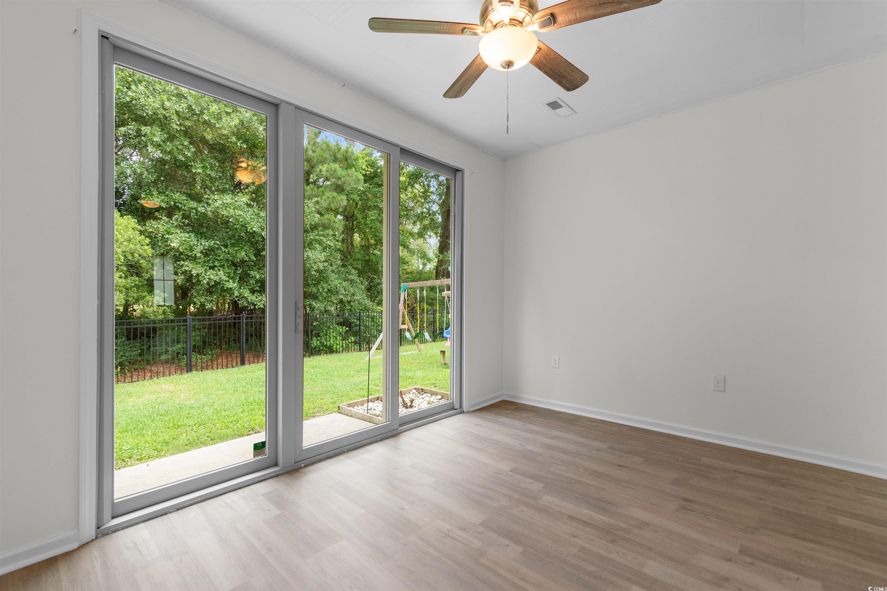 124 Shady Arbor Loop Longs, SC 29568 - Photo 13 of 40 Unfurnished room featuring wood finished floors and ceiling fan