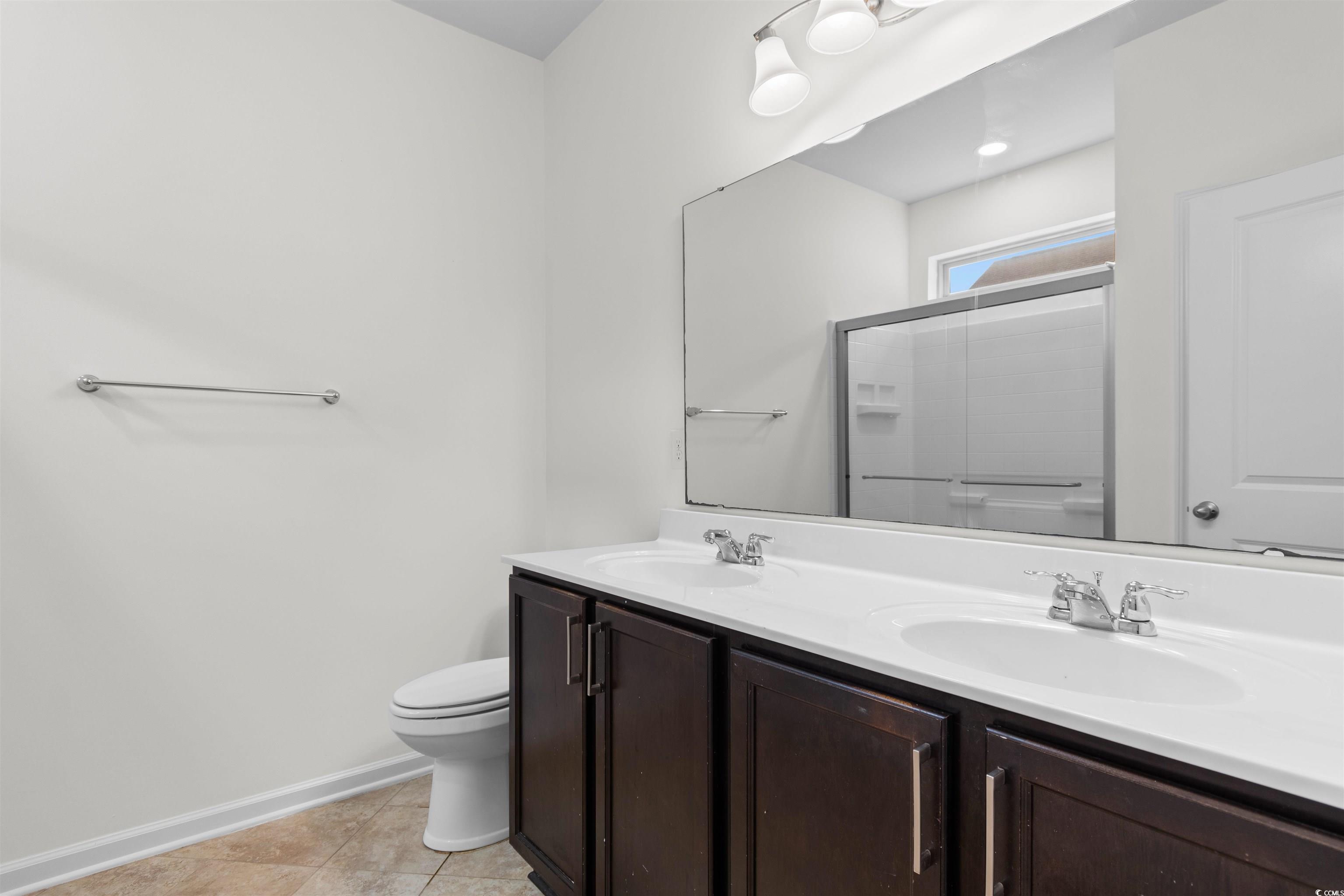 124 Shady Arbor Loop Longs, SC 29568 - Photo 17 of 40 Bathroom with double vanity and tile patterned floors