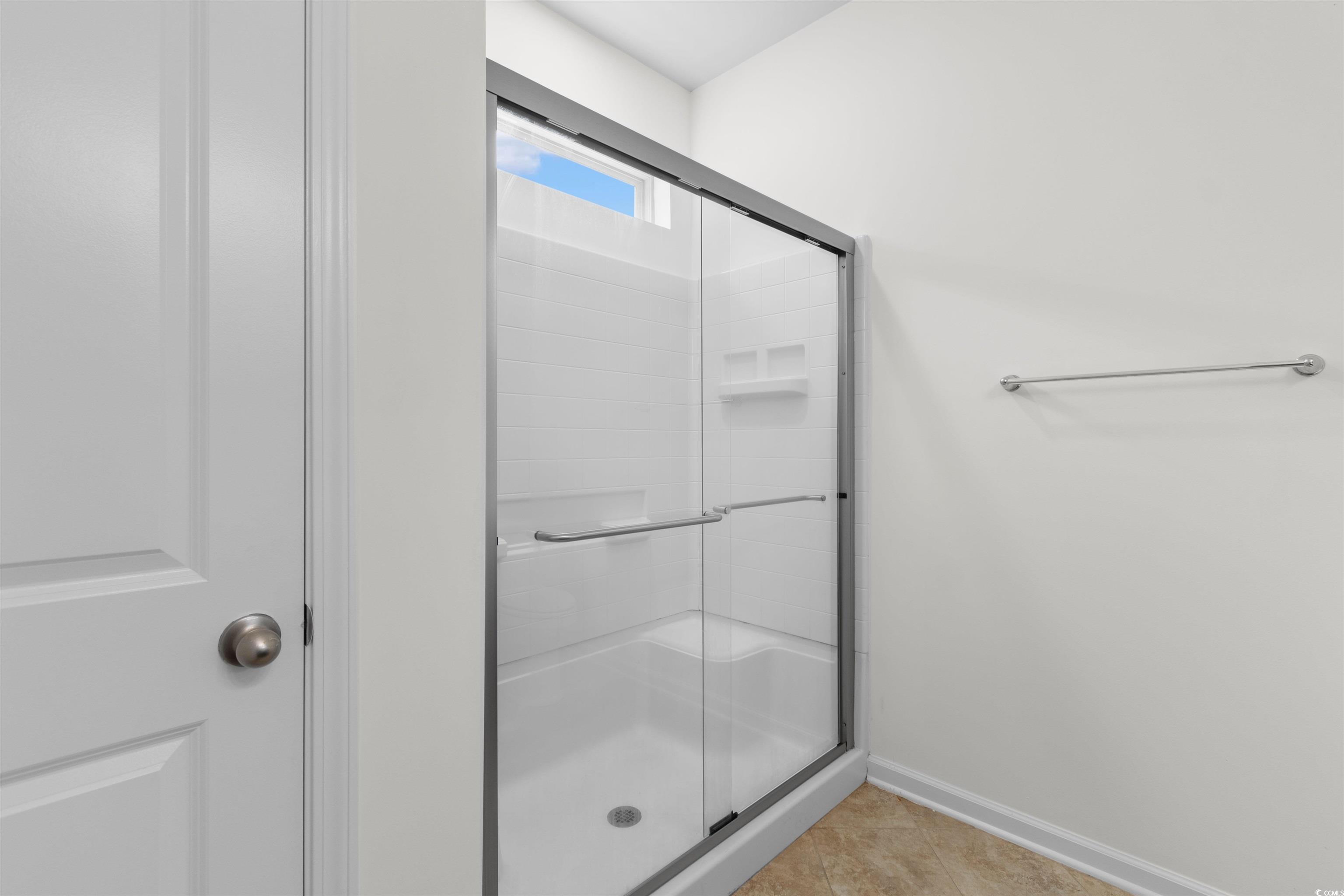 124 Shady Arbor Loop Longs, SC 29568 - Photo 18 of 40 Bathroom featuring a shower stall and tile patterned flooring