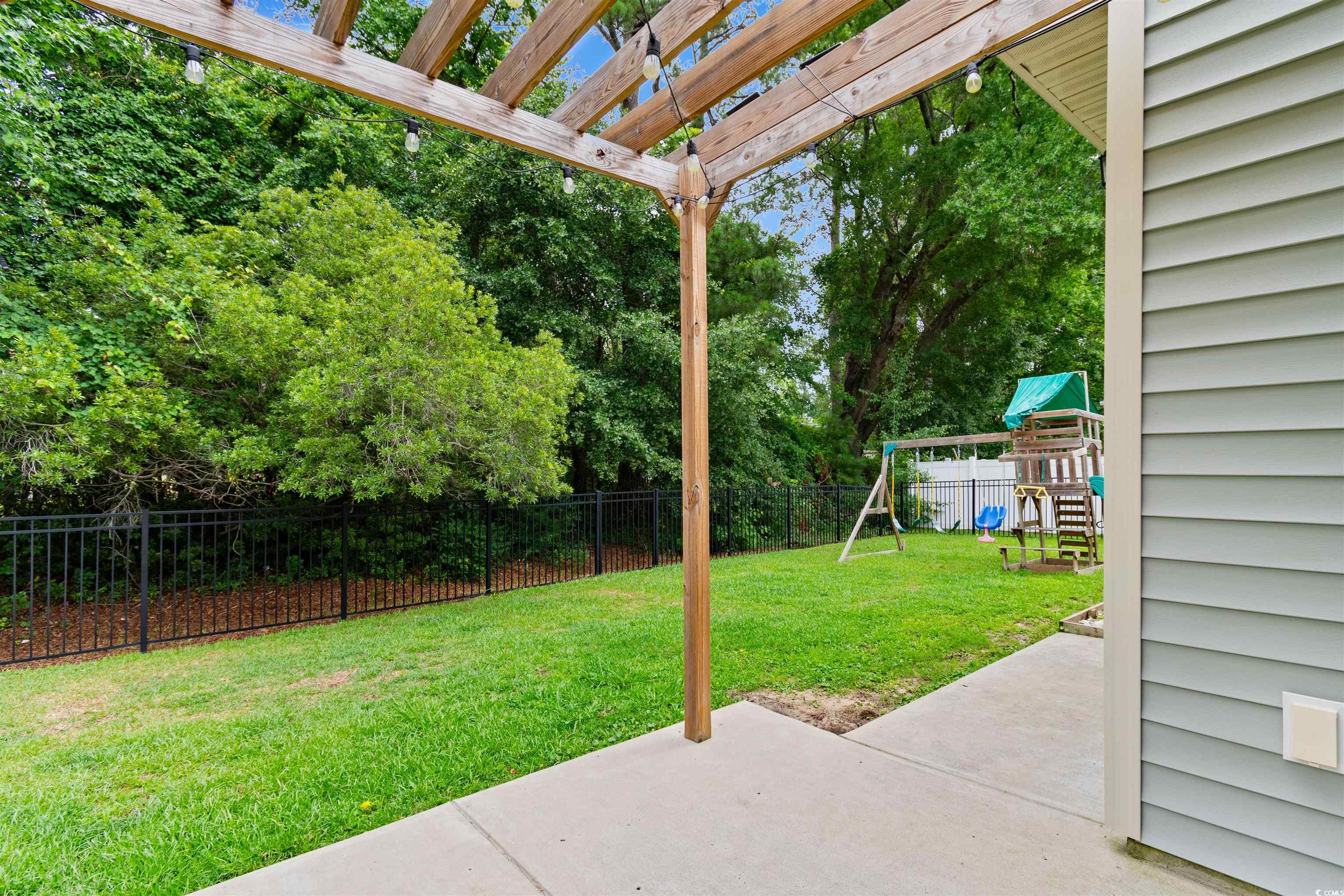 124 Shady Arbor Loop Longs, SC 29568 - Photo 26 of 40 Fenced backyard featuring a playground, a patio area, and a pergola