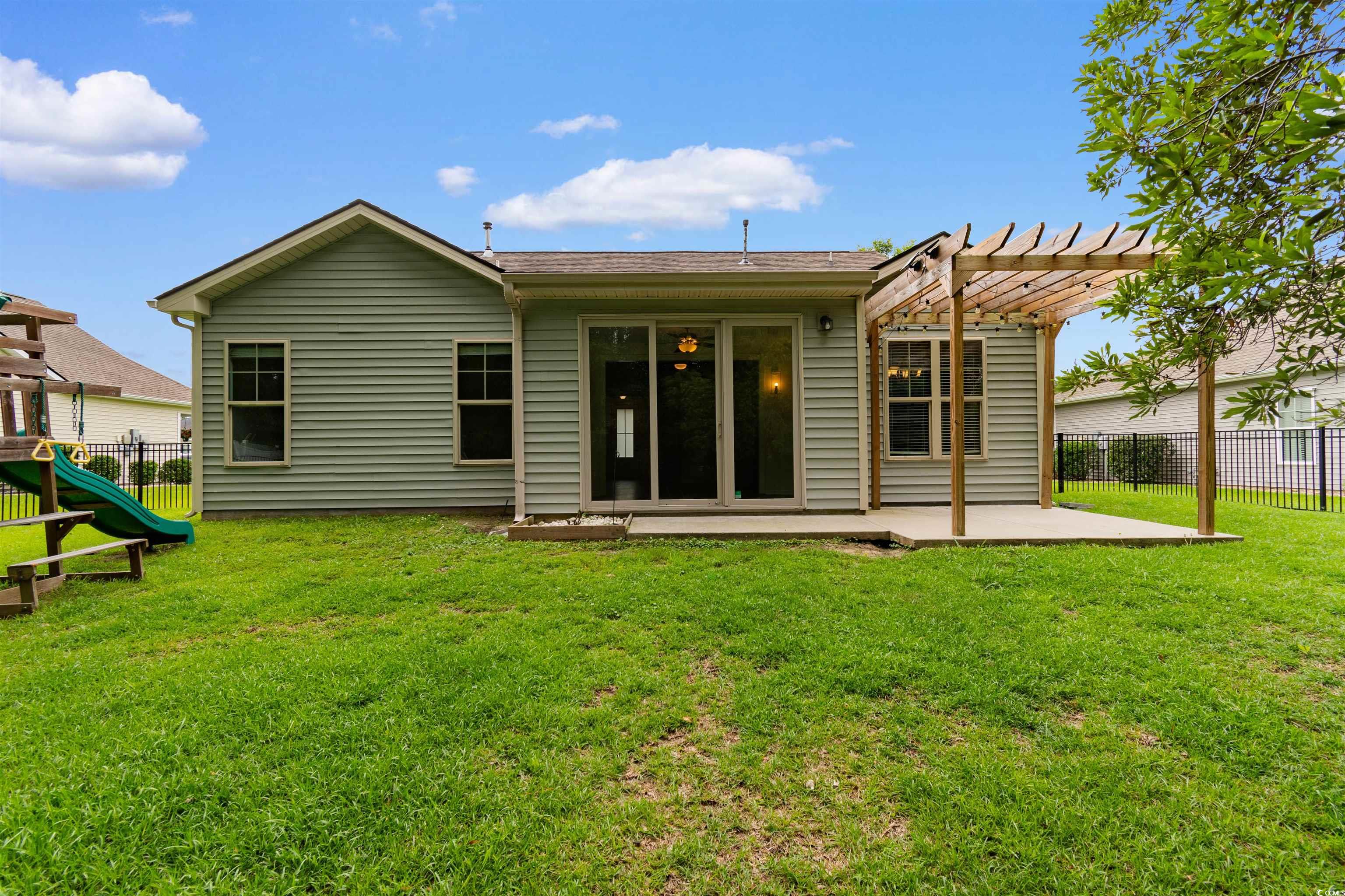 124 Shady Arbor Loop Longs, SC 29568 - Photo 28 of 40 Back of house featuring a patio, a pergola, and a playground