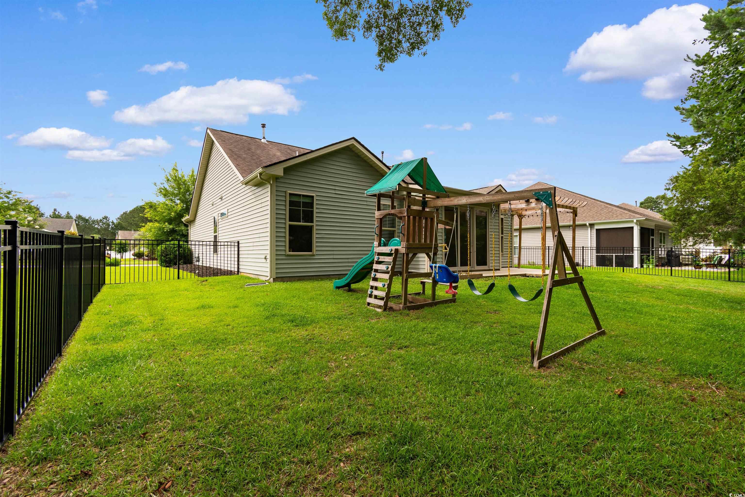 124 Shady Arbor Loop Longs, SC 29568 - Photo 29 of 40 Rear view of property featuring a playground and a fenced backyard