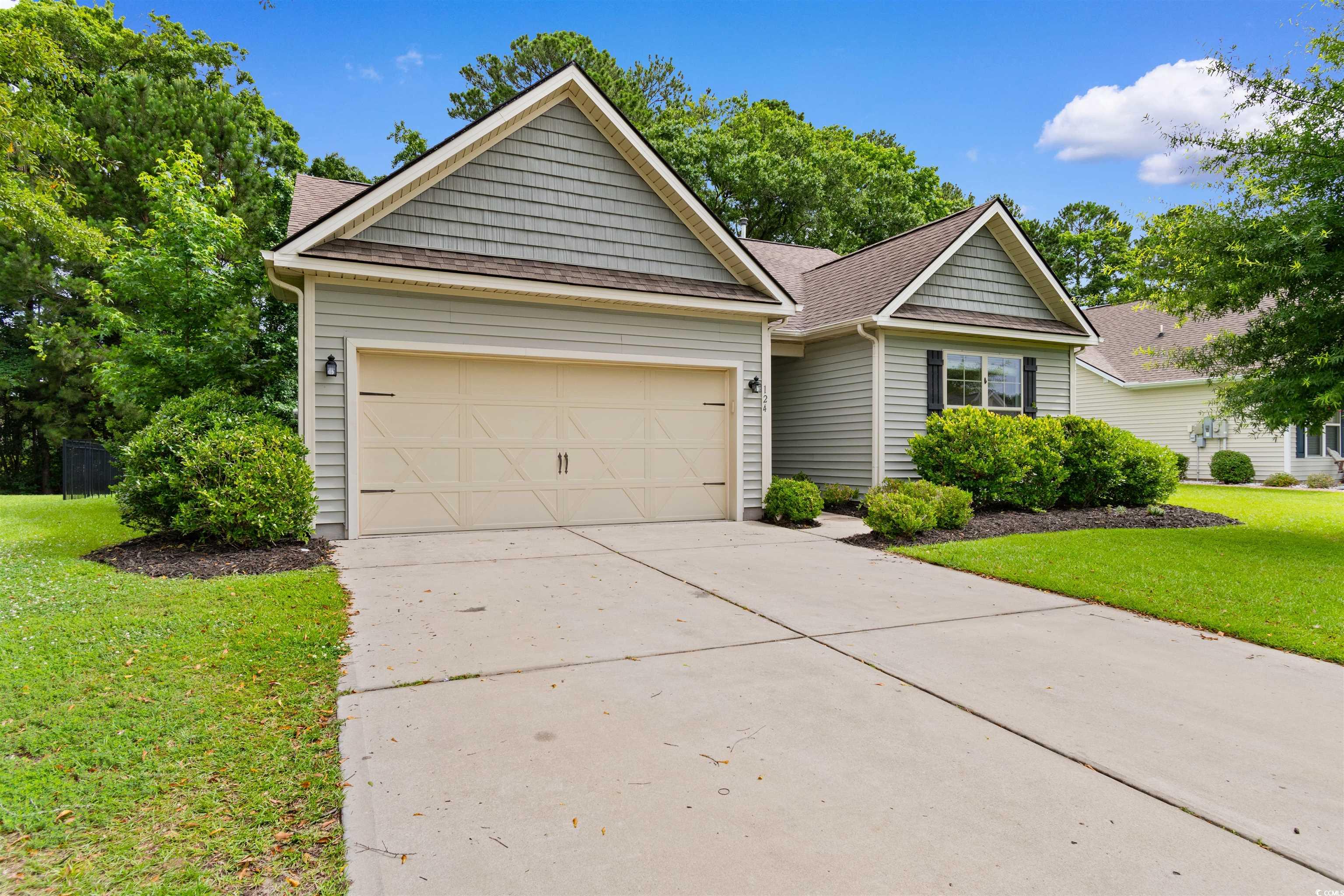 124 Shady Arbor Loop Longs, SC 29568 - Photo 30 of 40 View of front of property featuring concrete driveway, a garage, a front lawn, and a shingled roof