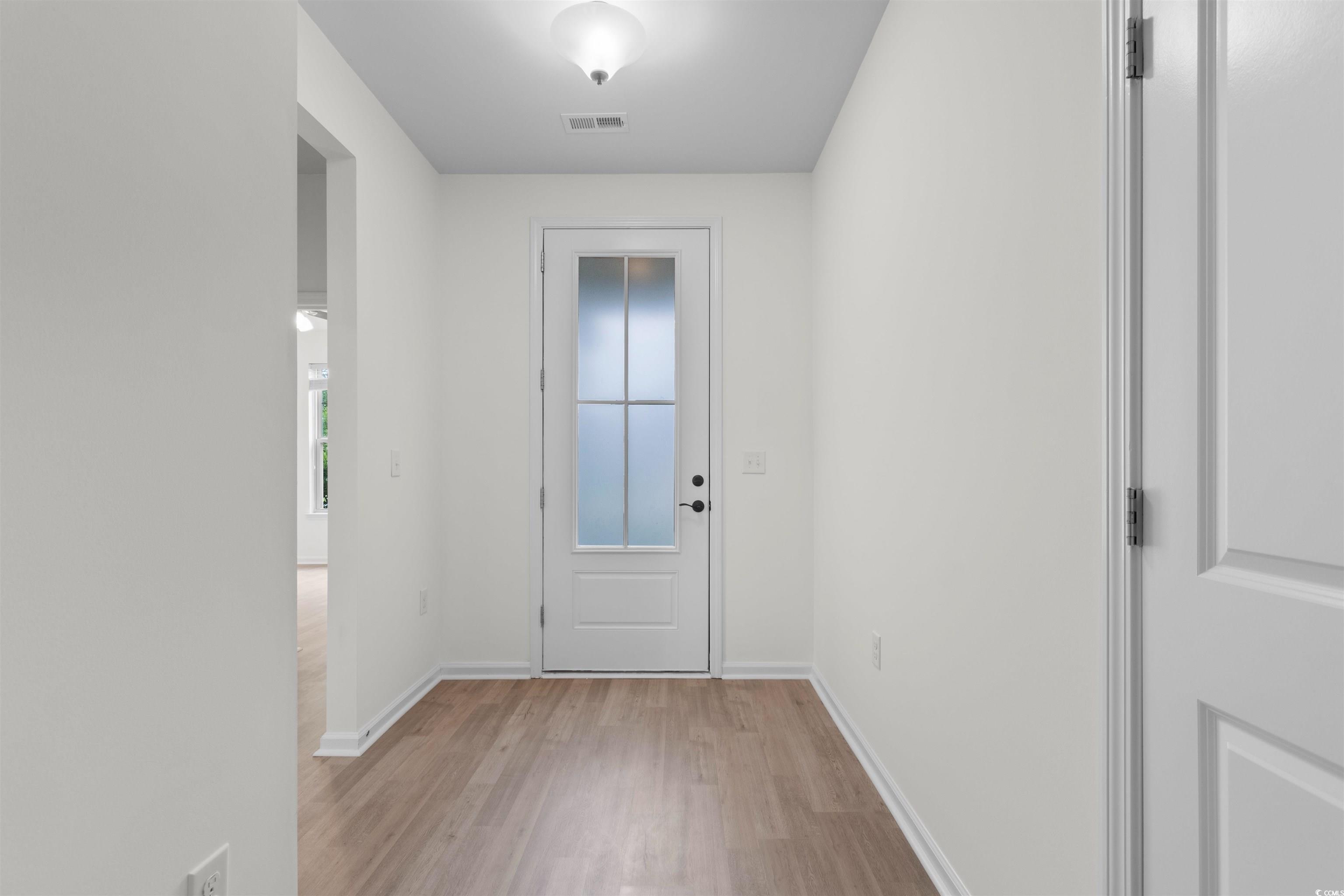 124 Shady Arbor Loop Longs, SC 29568 - Photo 35 of 40 Doorway to outside featuring light wood-type flooring and baseboards