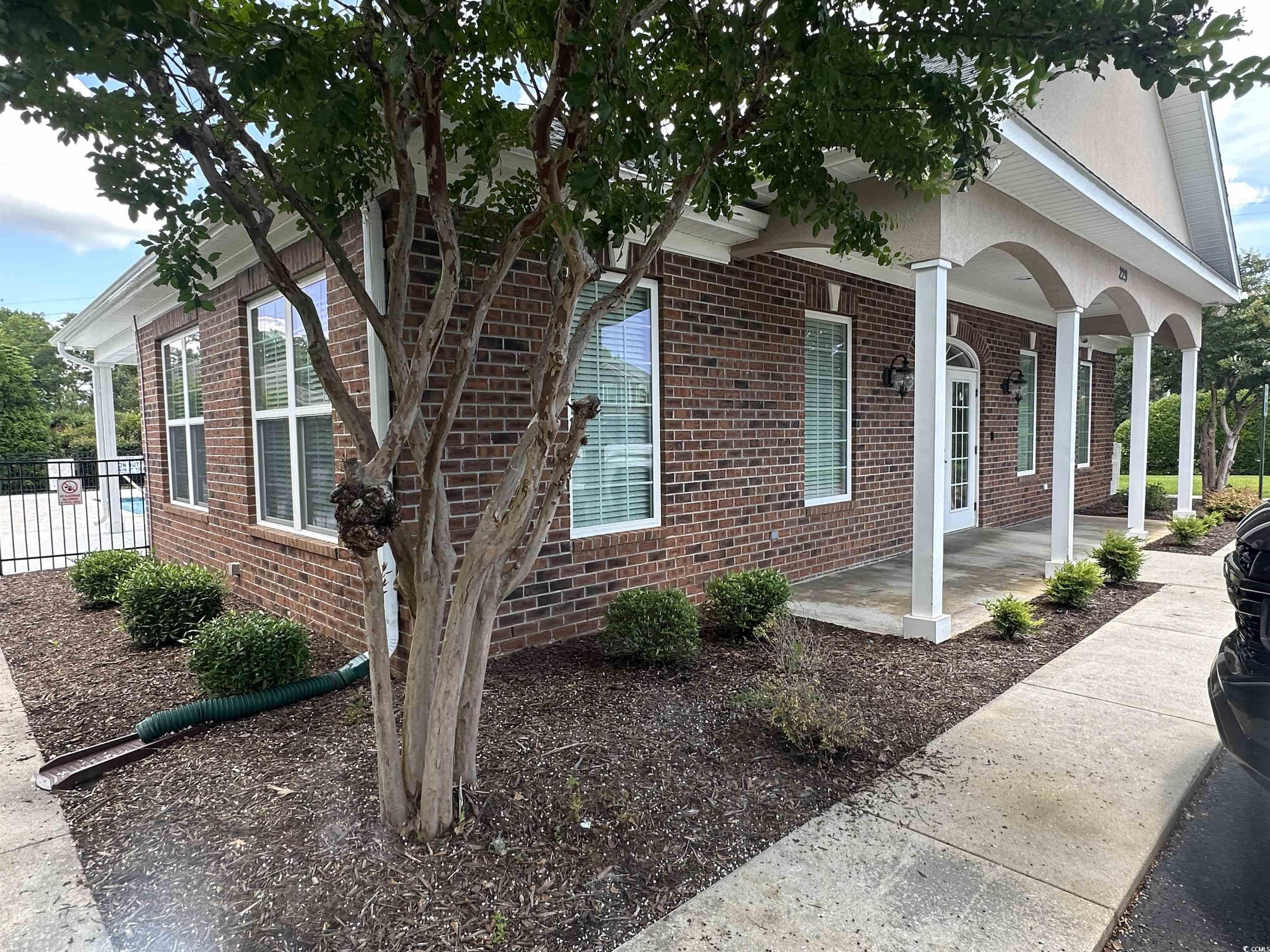 124 Shady Arbor Loop Longs, SC 29568 - Photo 37 of 40 View of side of property featuring brick siding and covered porch