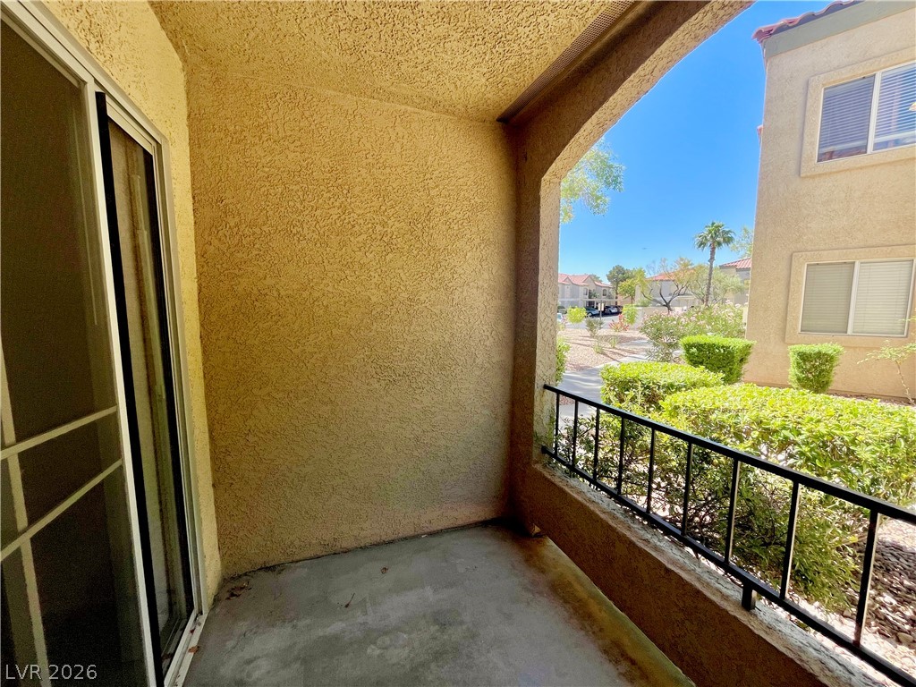 7885 West Flamingo Road, Unit 1029 Las Vegas, NV 89147 - Photo 18 of 18 An inviting balcony offers serene outdoor relaxation with garden and neighborhood views.