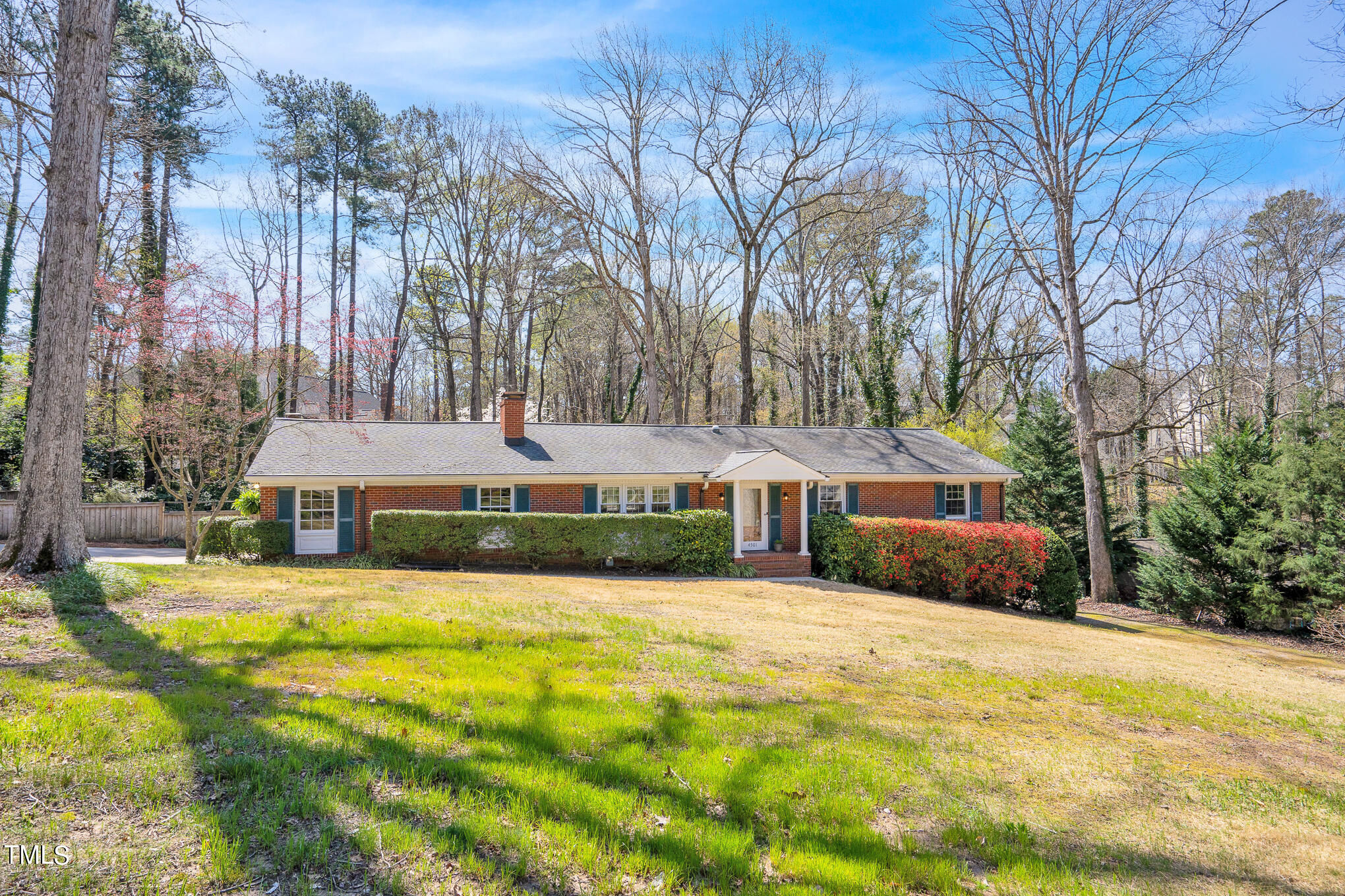 a front view of house with yard and green space