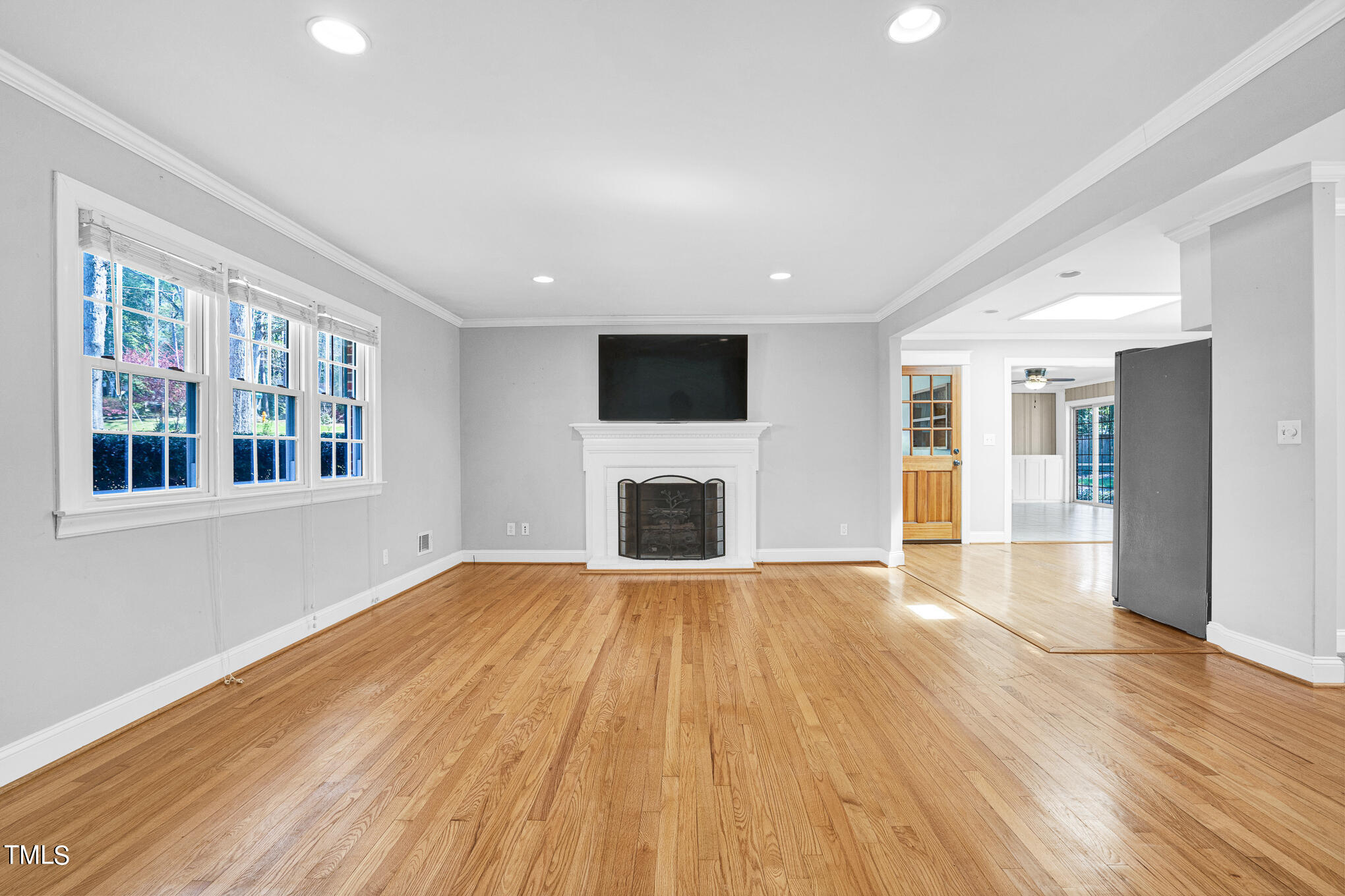 4501 Boxwood Road Raleigh, NC 27612 - Photo 16 of 44 a view of an empty room with wooden floor and a window