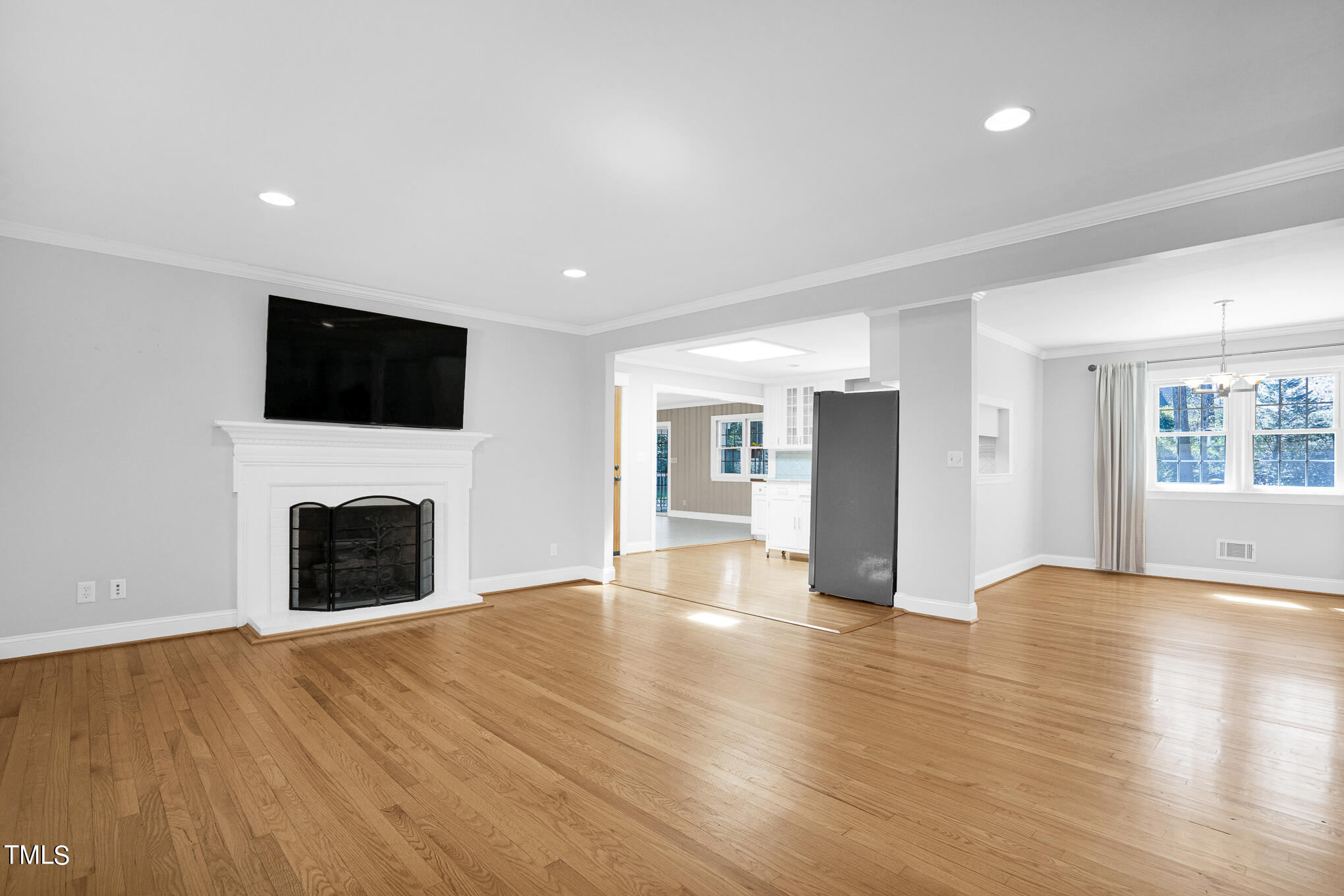 4501 Boxwood Road Raleigh, NC 27612 - Photo 17 of 44 a view of a livingroom with a fireplace wooden floor and window