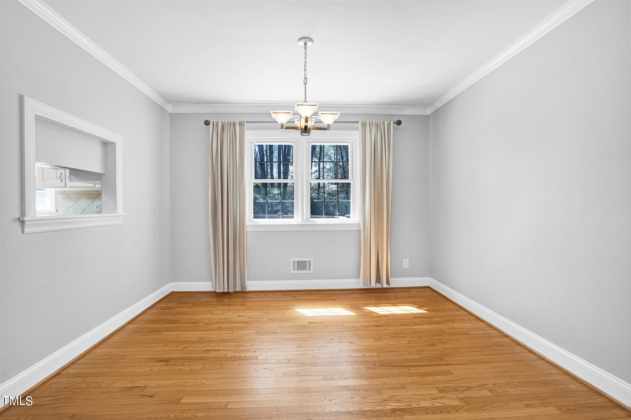 4501 Boxwood Road Raleigh, NC 27612 - Photo 19 of 44 a view of an empty room with wooden floor and a window