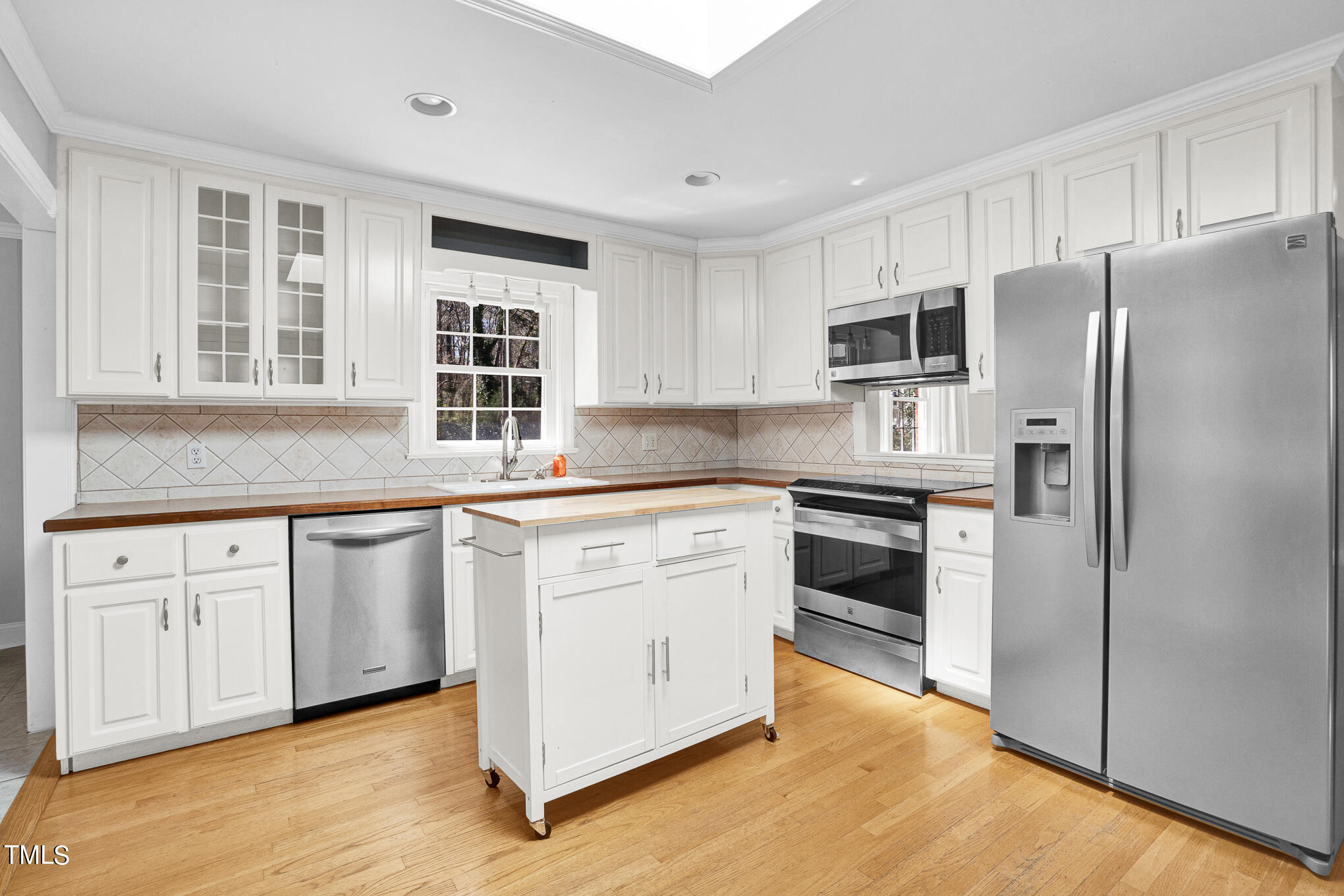 4501 Boxwood Road Raleigh, NC 27612 - Photo 22 of 44 a kitchen with granite countertop white cabinets and stainless steel appliances