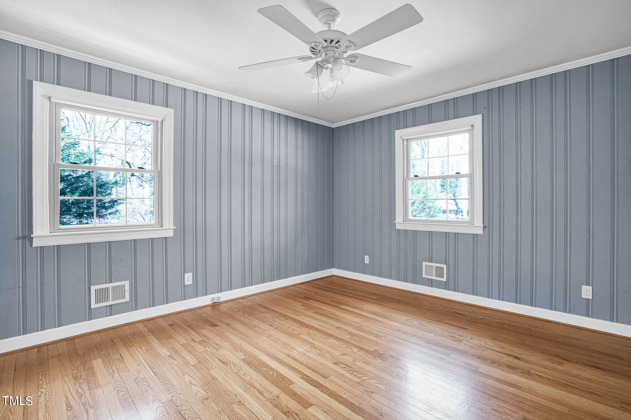 4501 Boxwood Road Raleigh, NC 27612 - Photo 28 of 44 a view of an empty room with a window and wooden floor