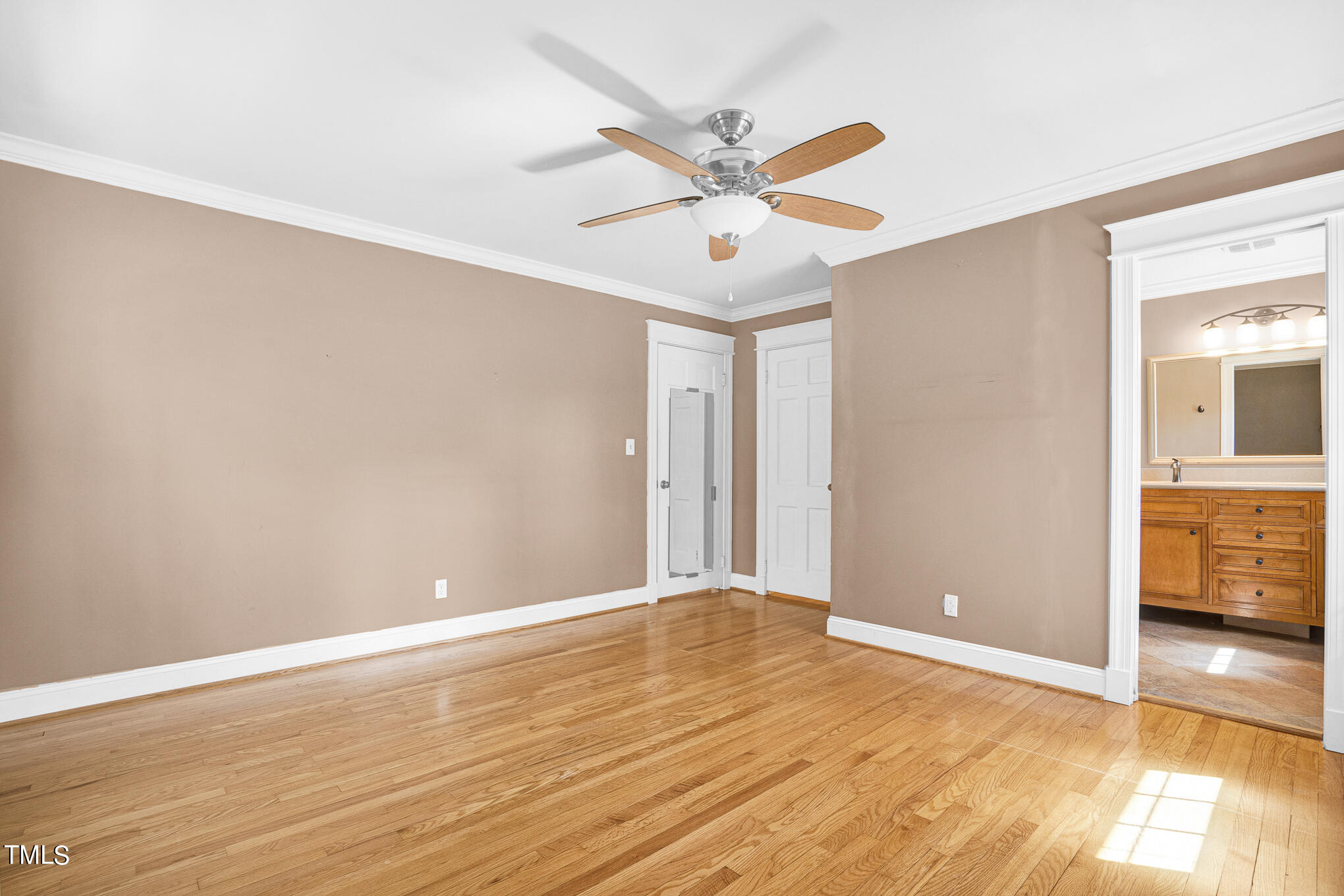 4501 Boxwood Road Raleigh, NC 27612 - Photo 29 of 44 an empty room with wooden floor fan and windows