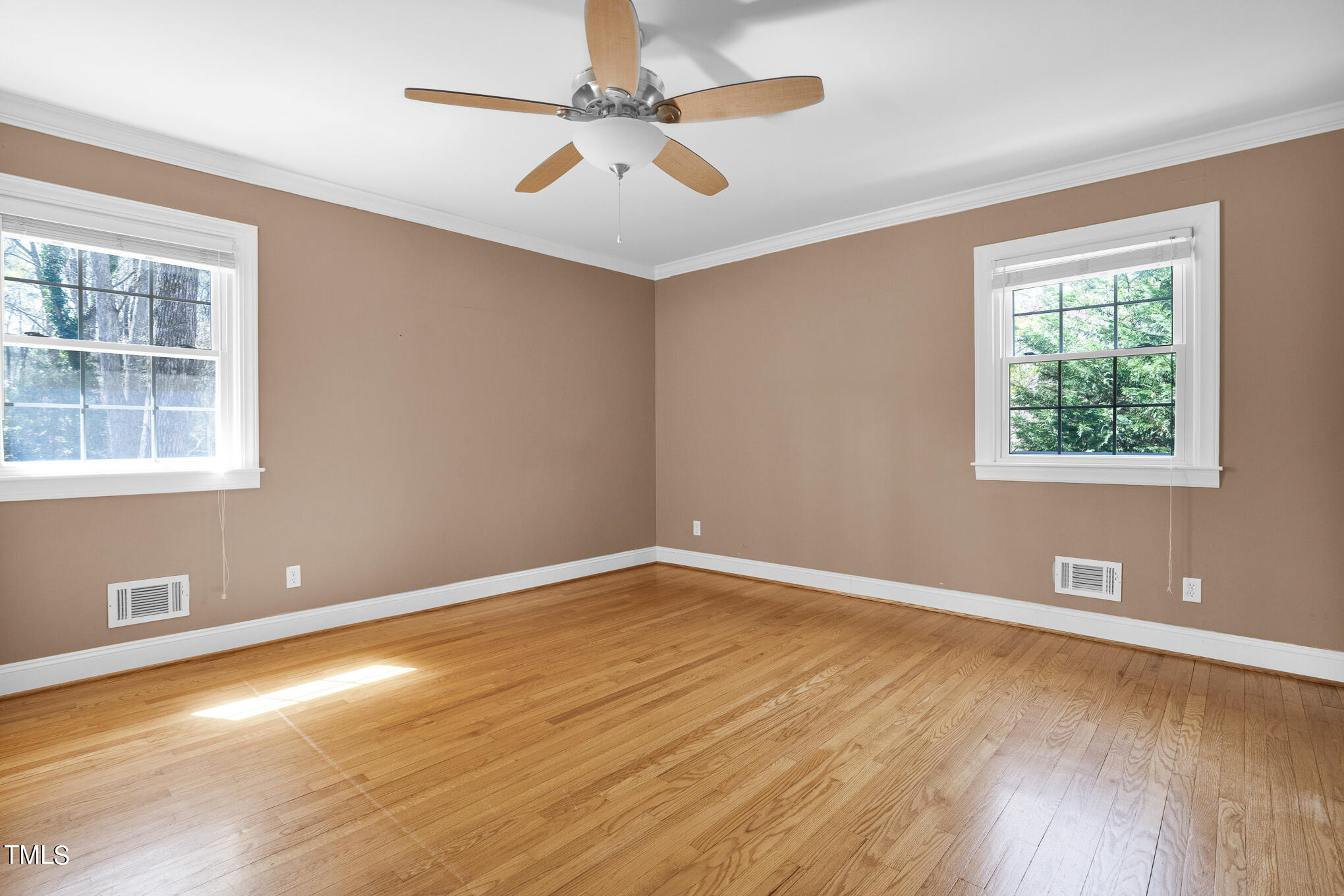 4501 Boxwood Road Raleigh, NC 27612 - Photo 30 of 44 an empty room with wooden floor and windows